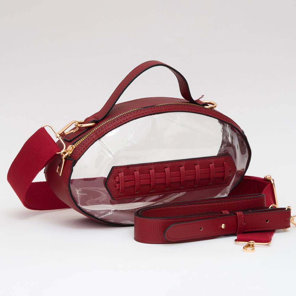 Clear football-shaped crossbody bag with garnet trim, zipper closure, and adjustable straps.