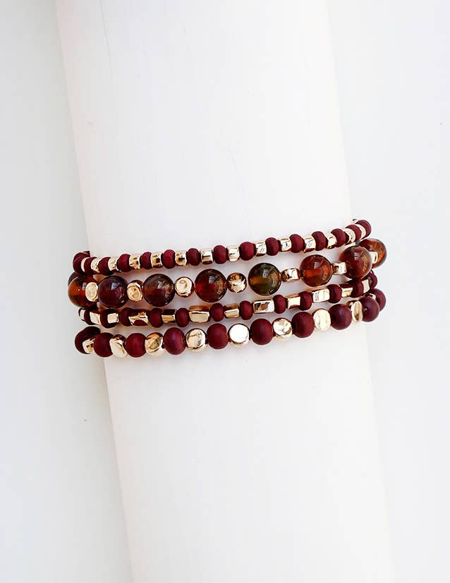 Four-stack beaded bracelet set with deep maroon, garnet, and cream beads of varying sizes