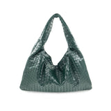Green woven shoulder bag with soft structure and magnetic closure, designed for stylish and functional everyday use