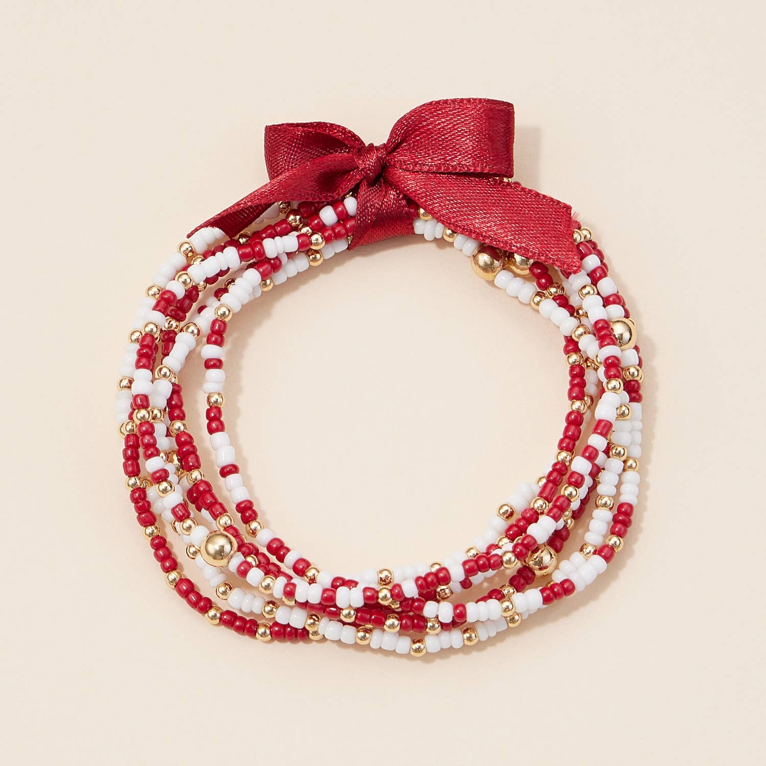 Multi-strand garnet, white, and gold beaded bracelet with satin ribbon tie