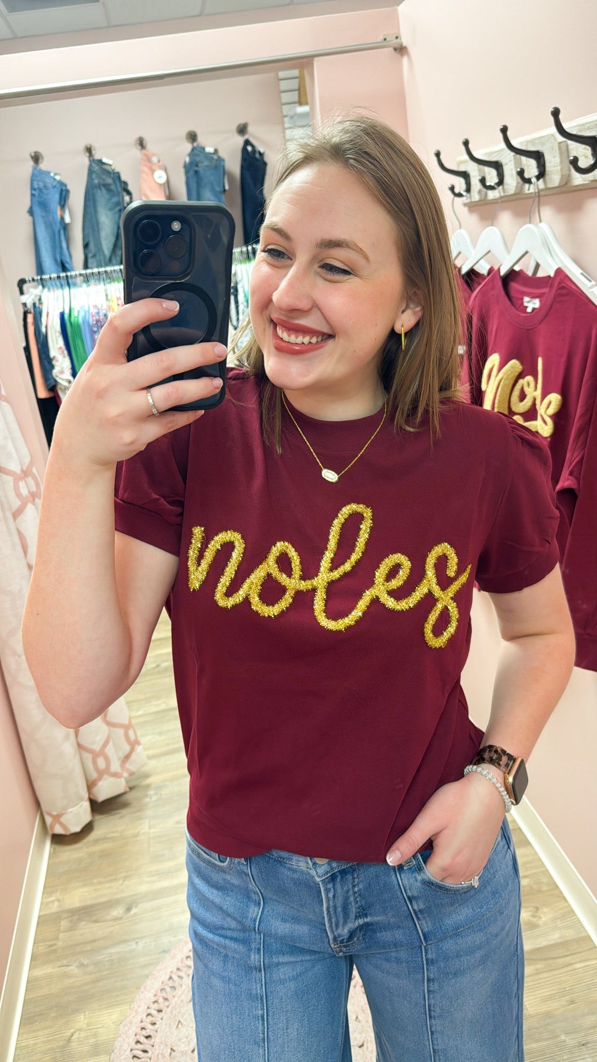 Lightweight garnet short-sleeve sweater top with gold tinsel “Noles” lettering across the chest