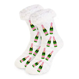 Soft slipper socks with pink and green champagne bottle design, fluffy cuff, and grip bottoms.