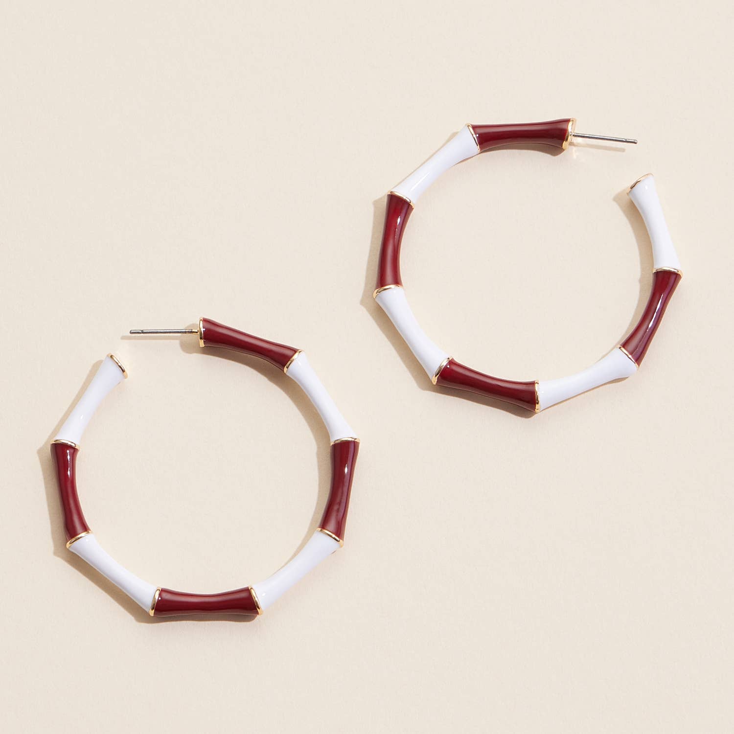 Garnet and white striped enamel hoop earrings with gold trim
