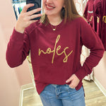 Garnet crewneck sweatshirt with gold braided rope embroidery spelling “Noles” on the front
