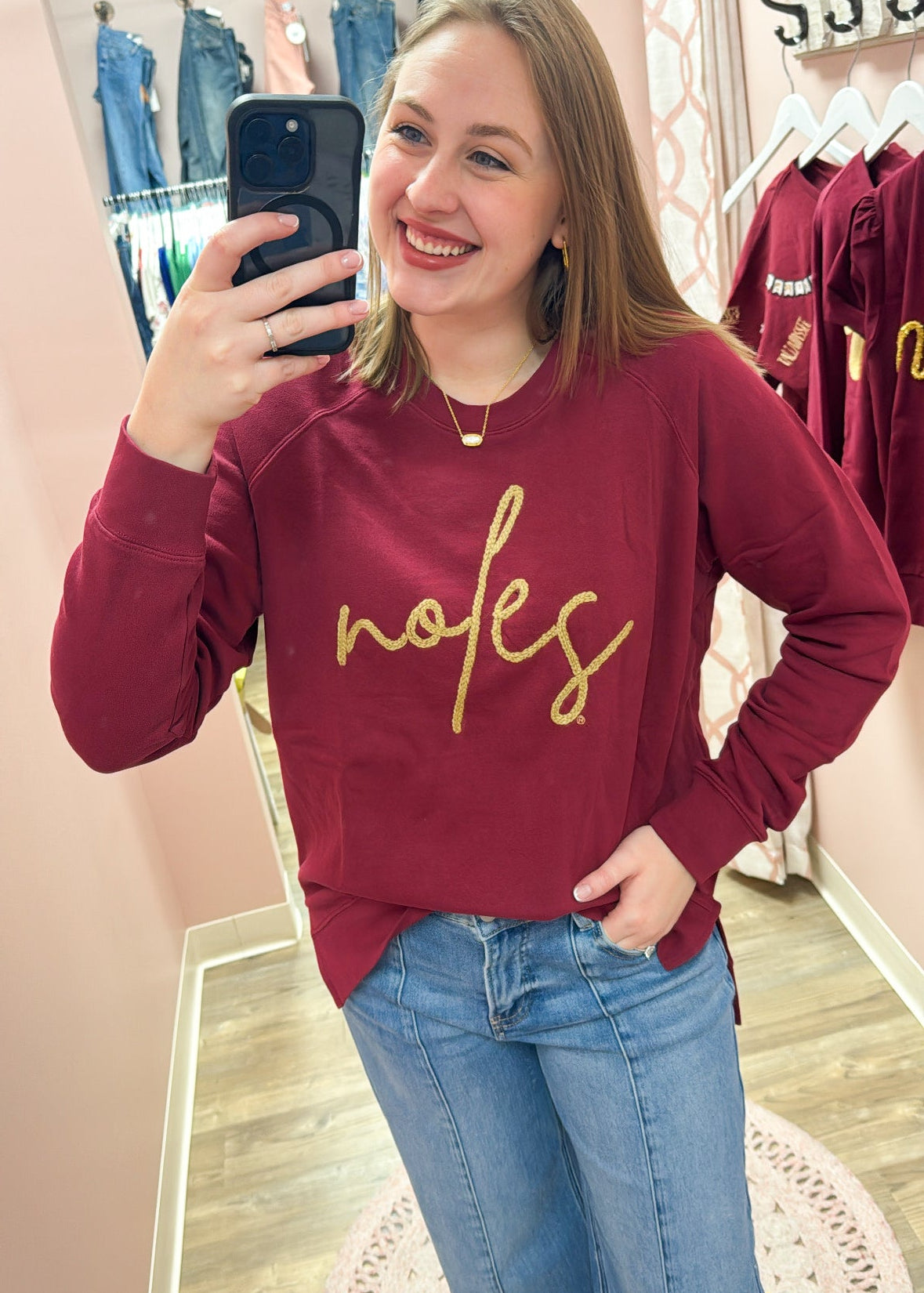 Garnet crewneck sweatshirt with gold braided rope embroidery spelling “Noles” on the front