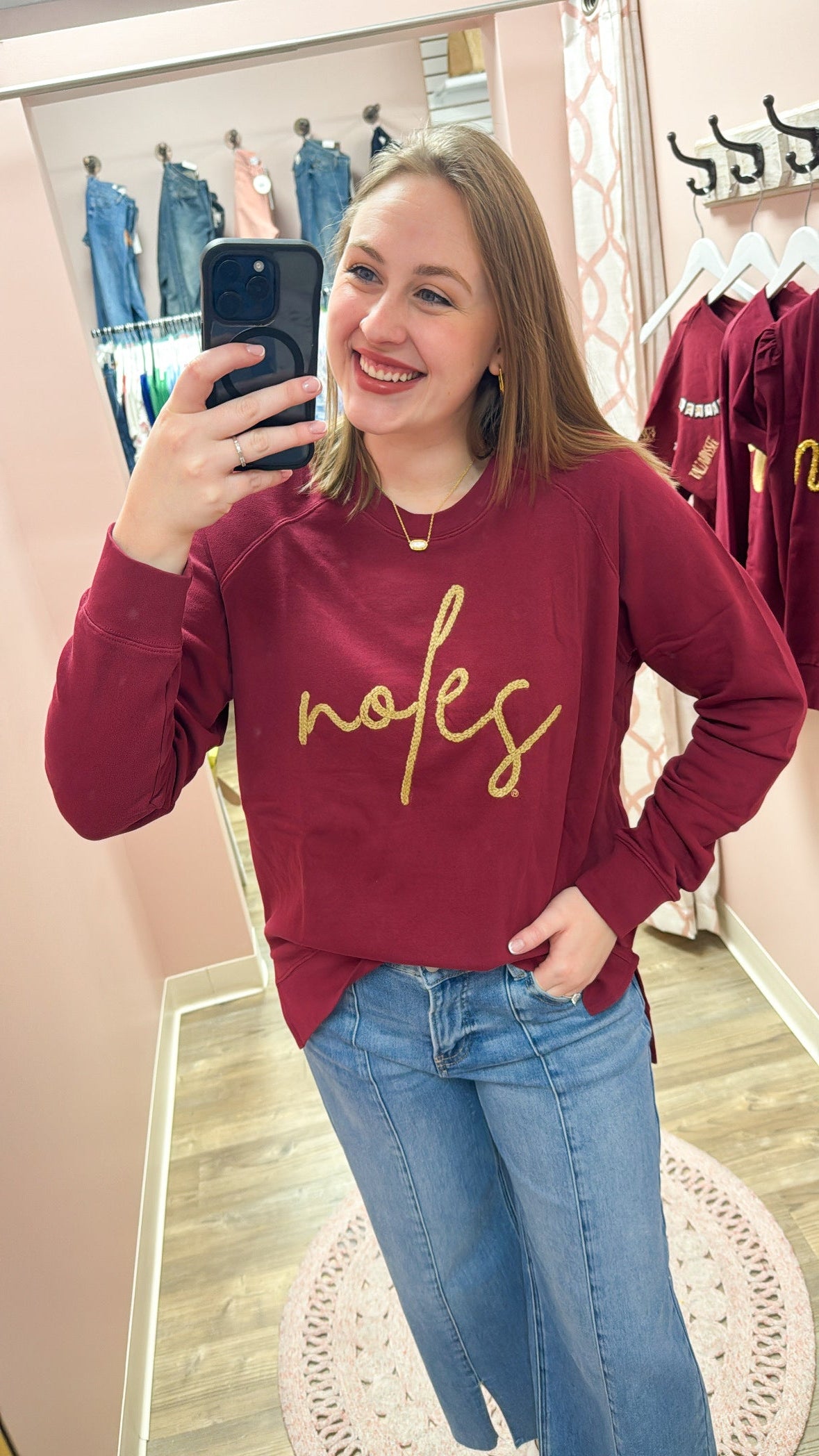 Garnet crewneck sweatshirt with gold braided rope embroidery spelling “Noles” on the front
