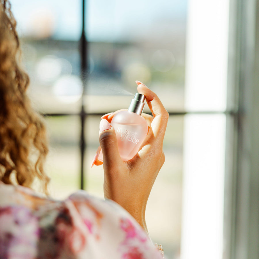 Soft pink perfume bottle styled
