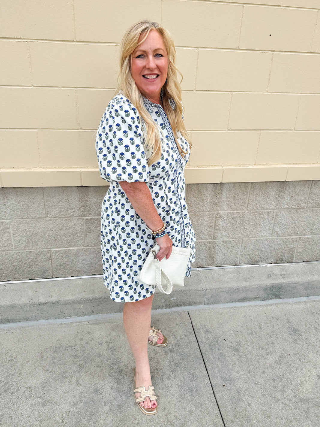 Navy floral dress with puff sleeves, button-down front, and collar