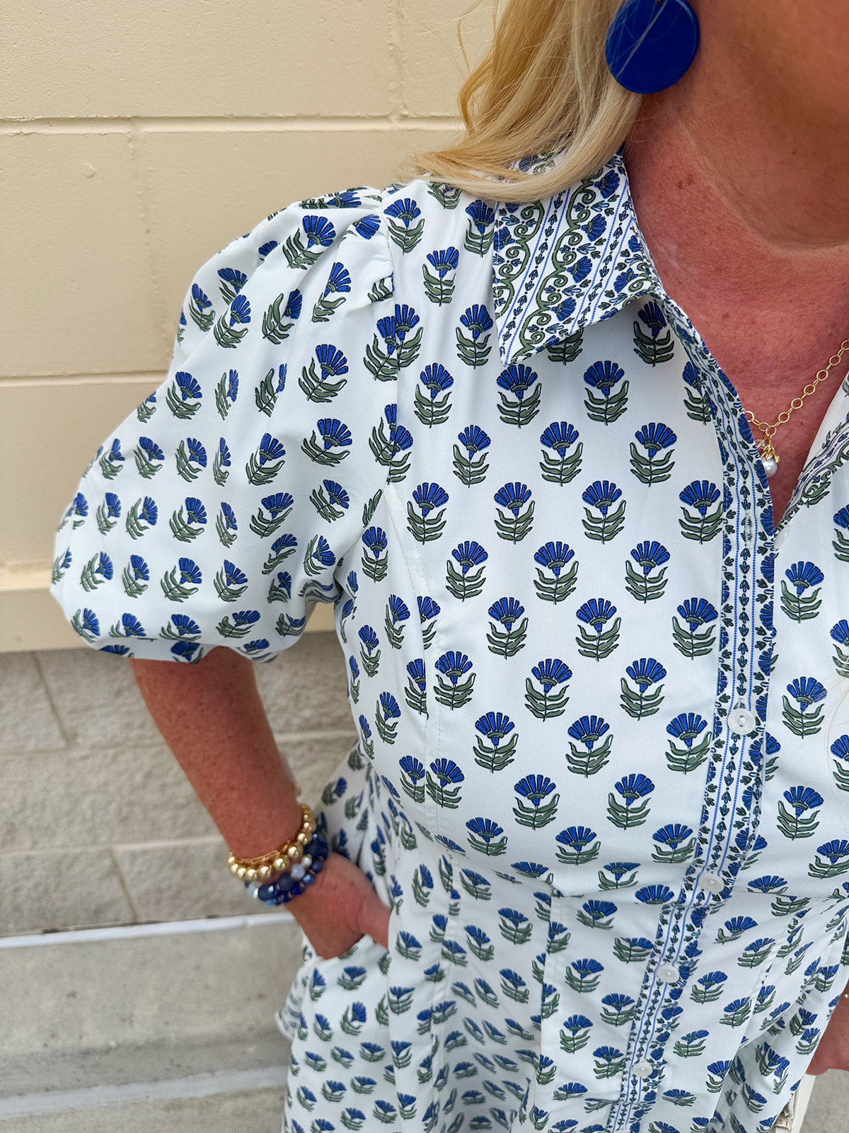 Navy floral dress with puff sleeves, button-down front, and collar