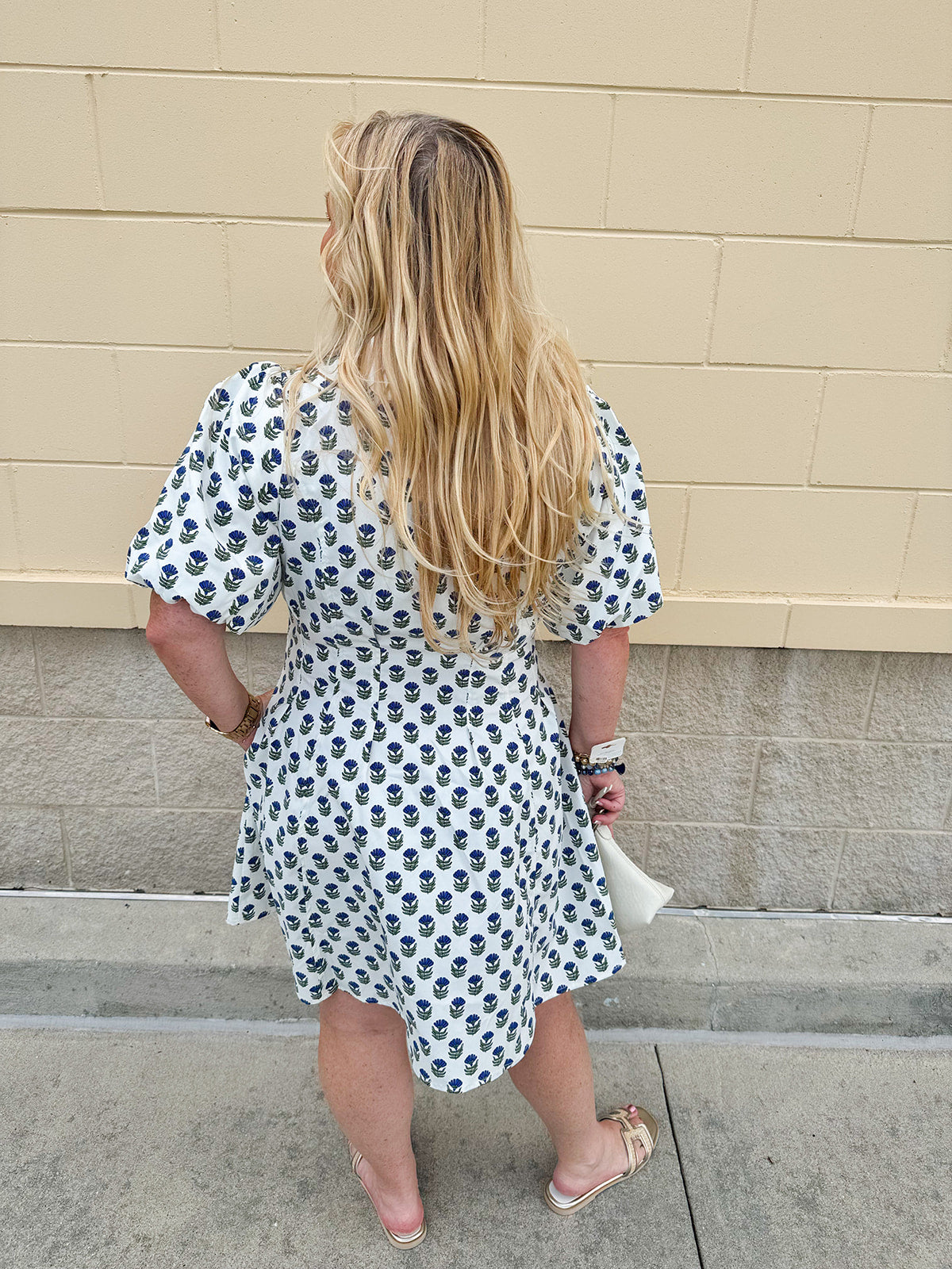 Navy floral dress with puff sleeves, button-down front, and collar