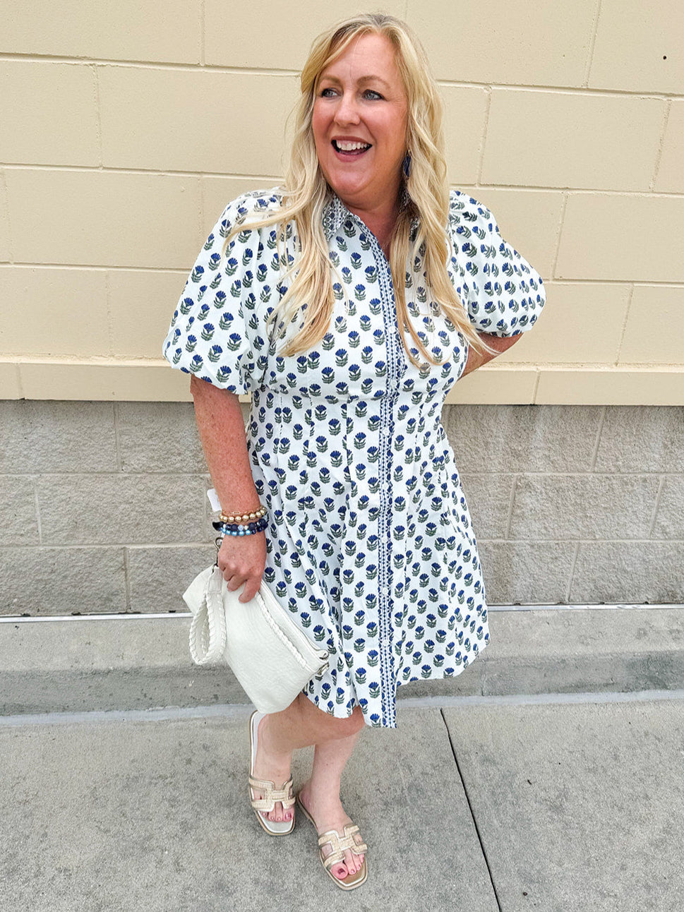 Navy floral dress with puff sleeves, button-down front, and collar