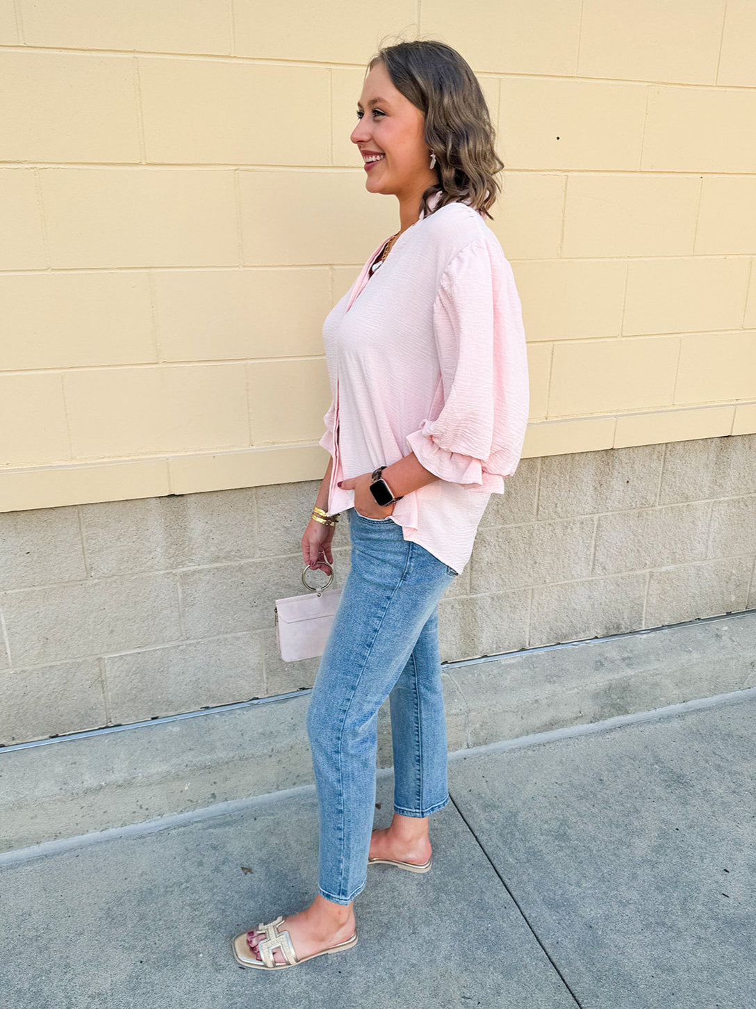 Blush blouse with V-neckline, balloon sleeves, front pleat, and ruffle-trimmed cuffs