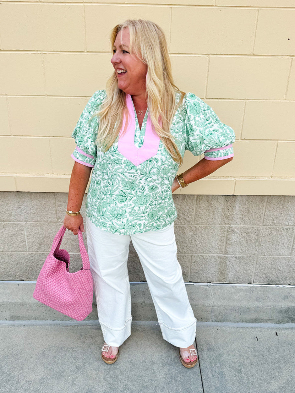 Green floral print caftan-style top with puff sleeves, split neckline, and lightweight fabric for effortless style.