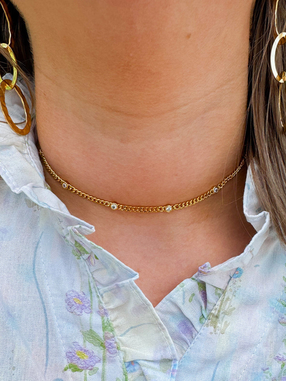 Delicate gold choker with sparkling cubic zirconia accents—elegant, dainty, and perfect for layering or wearing solo.