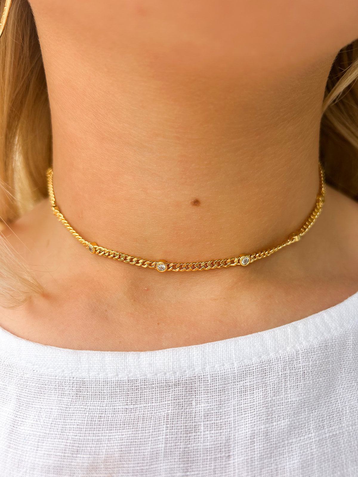 Delicate gold choker with sparkling cubic zirconia accents—elegant, dainty, and perfect for layering or wearing solo.