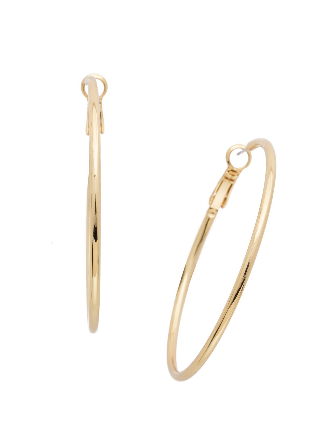 Long, slender gold hoop earrings with crystal shimmer and secure clip back closure