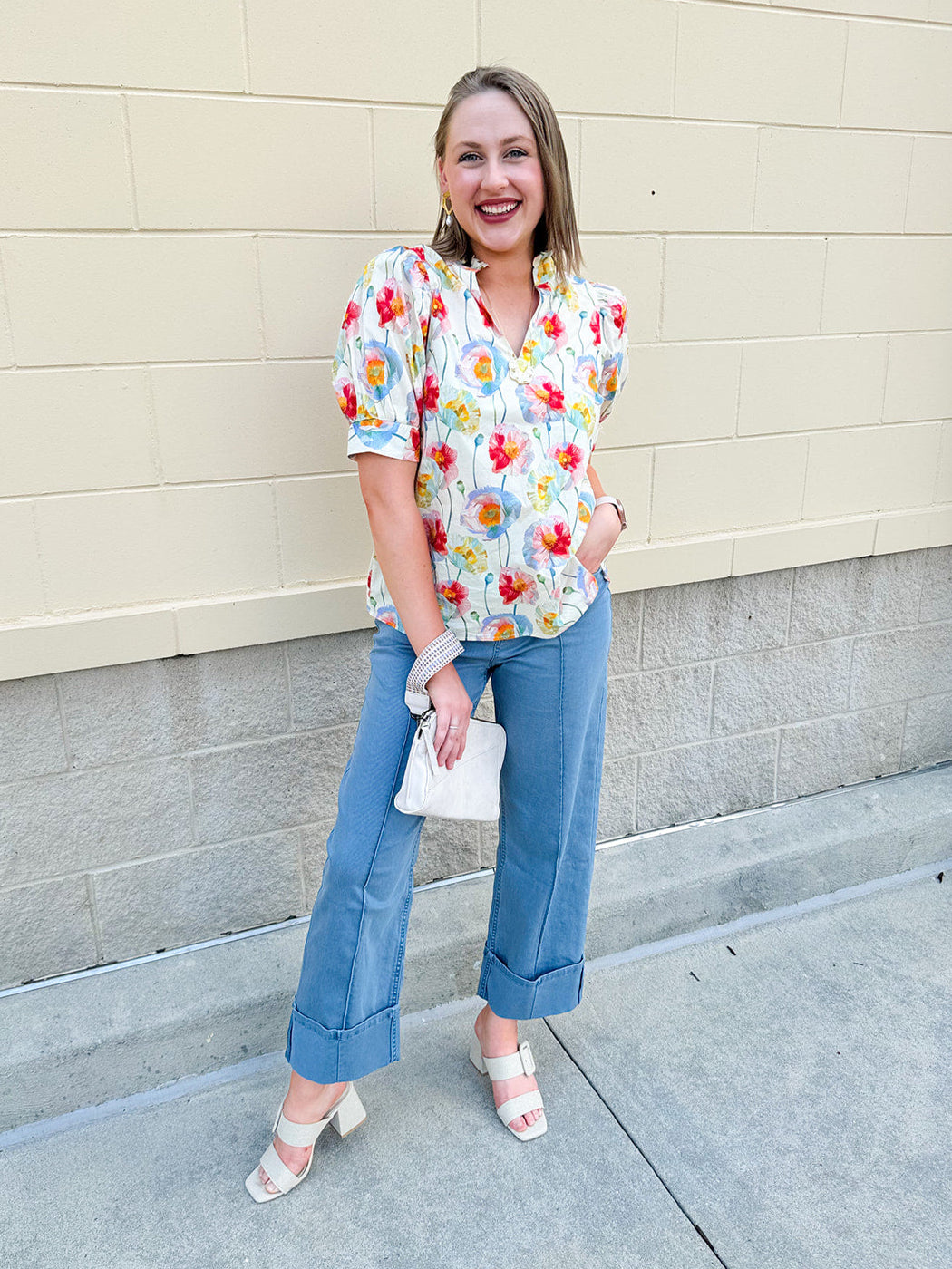 Lightweight floral blouse with puff sleeves and a pleated collar in soft cream with colorful floral print