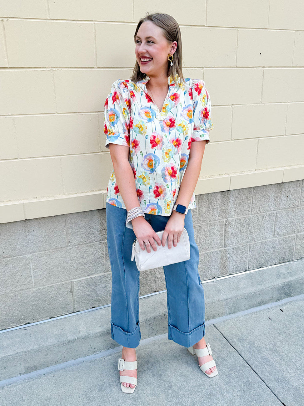 Lightweight floral blouse with puff sleeves and a pleated collar in soft cream with colorful floral print