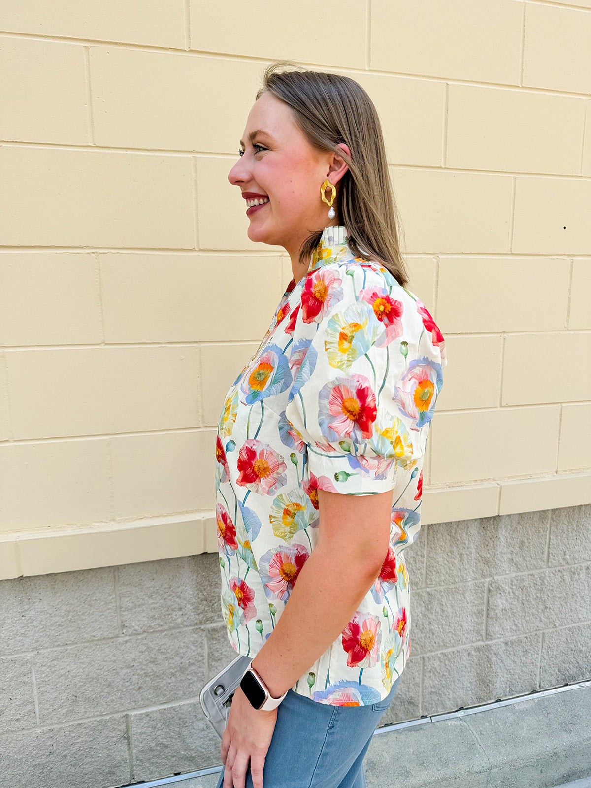 Lightweight floral blouse with puff sleeves and a pleated collar in soft cream with colorful floral print