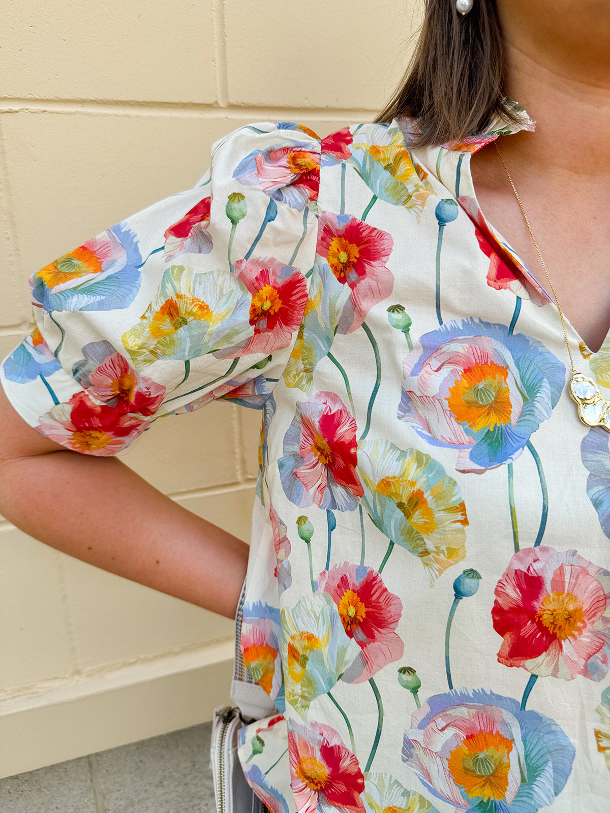 Lightweight floral blouse with puff sleeves and a pleated collar in soft cream with colorful floral print