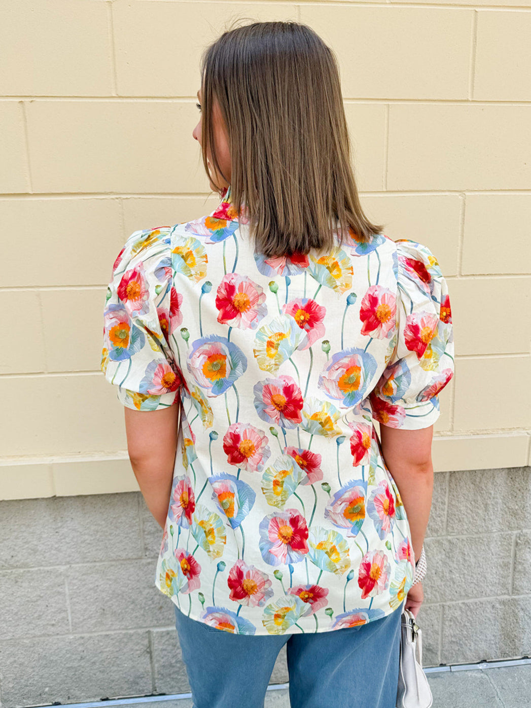 Lightweight floral blouse with puff sleeves and a pleated collar in soft cream with colorful floral print