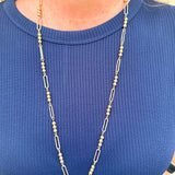 Water-resistant gold necklace with delicate beading and open oval chain, ideal for layering and everyday wear