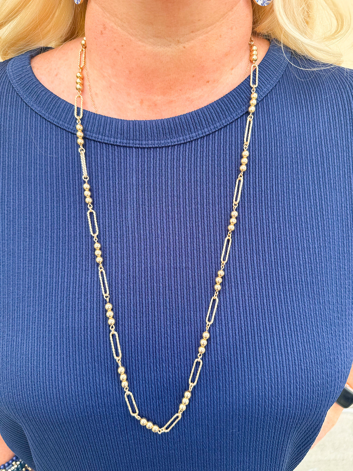 Water-resistant gold necklace with delicate beading and open oval chain, ideal for layering and everyday wear
