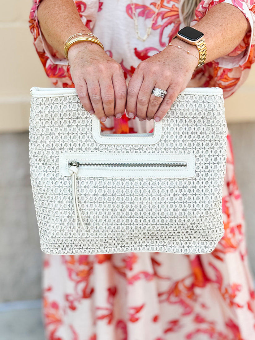 "Joy Susan Rio Faux Cane Cutout Handle Tote Bag displayed with its structured silhouette, faux cane cutout handles, and sleek vegan leather finish – styled as a versatile accessory for everyday or travel use."