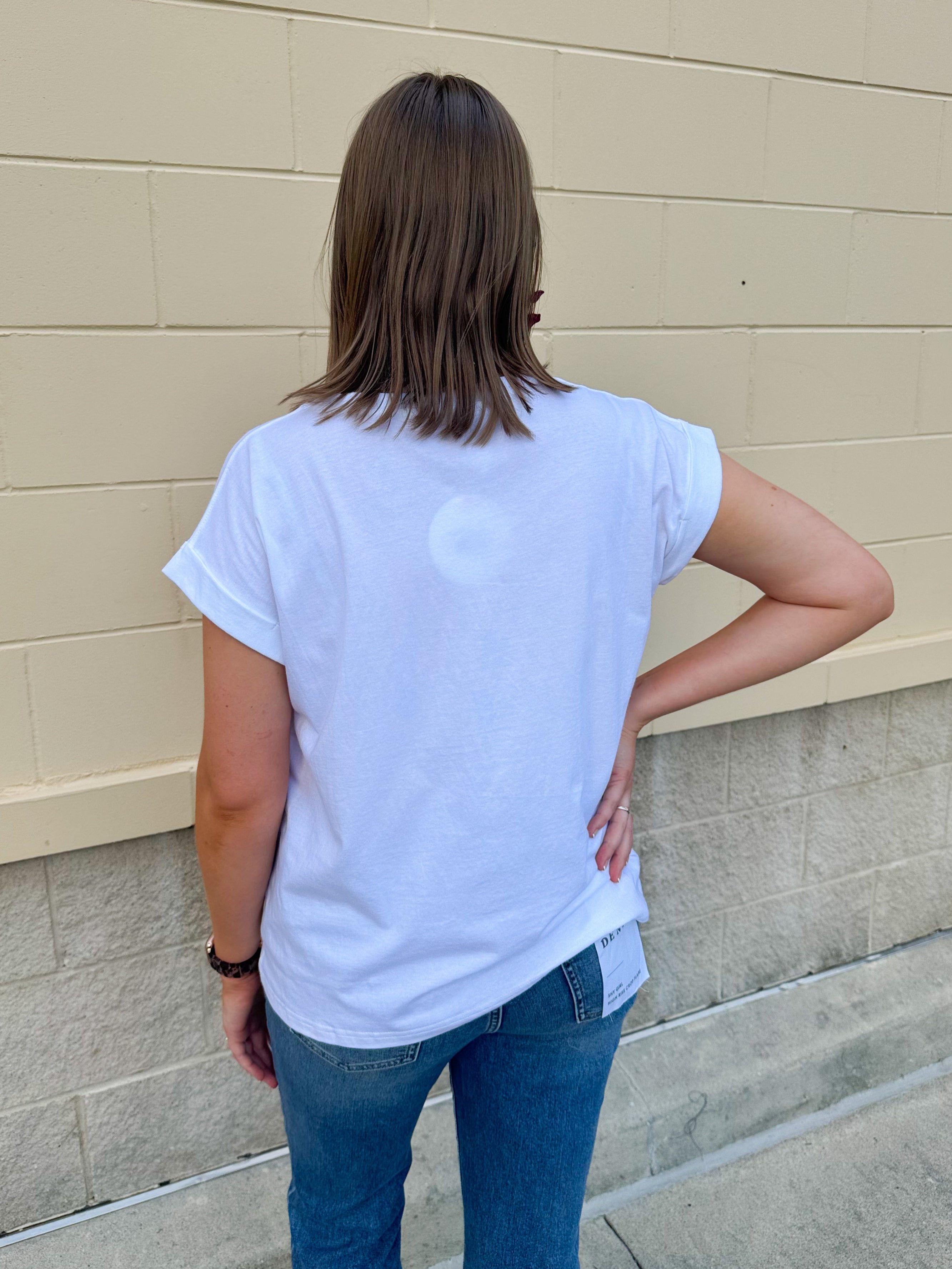 White rolled sleeve tee displayed on hanger or model, showing relaxed fit and classic style.