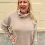 Taupe long-sleeve mock turtleneck knit top with high-low hemline in soft lightweight fabric.