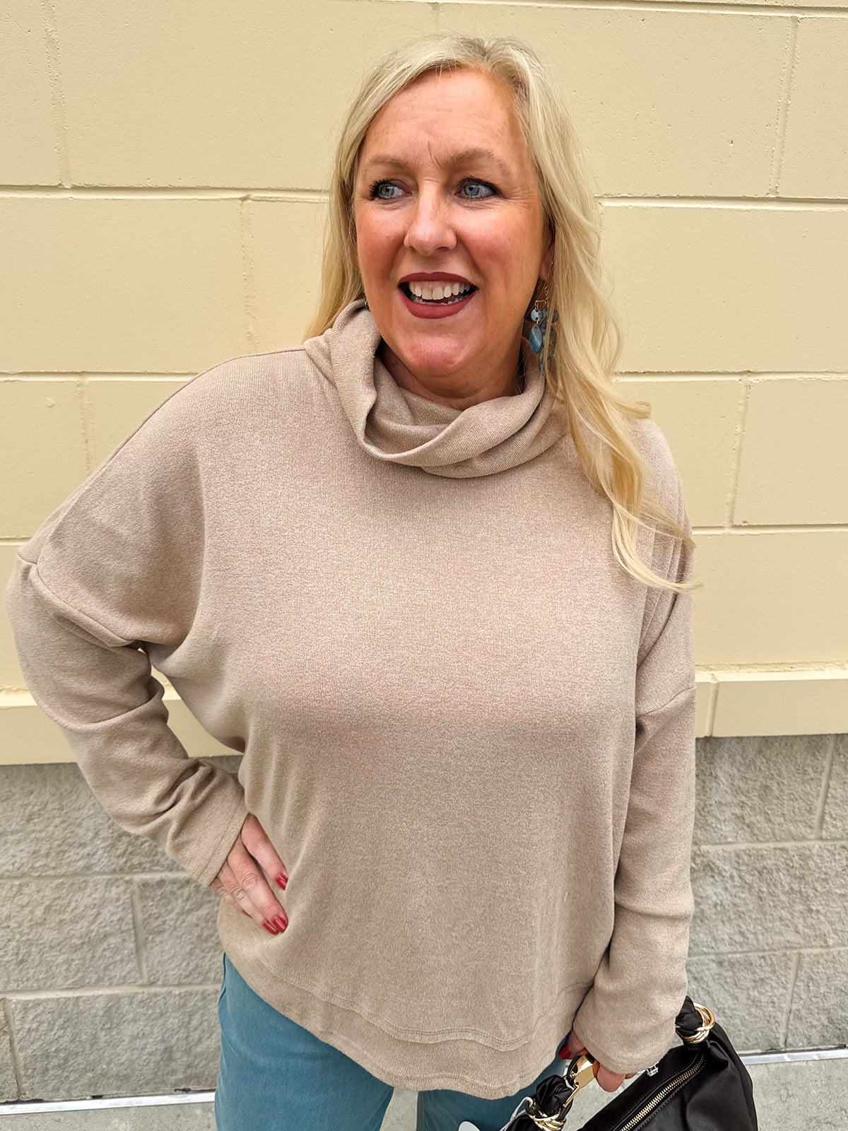 Taupe long-sleeve mock turtleneck knit top with high-low hemline in soft lightweight fabric.
