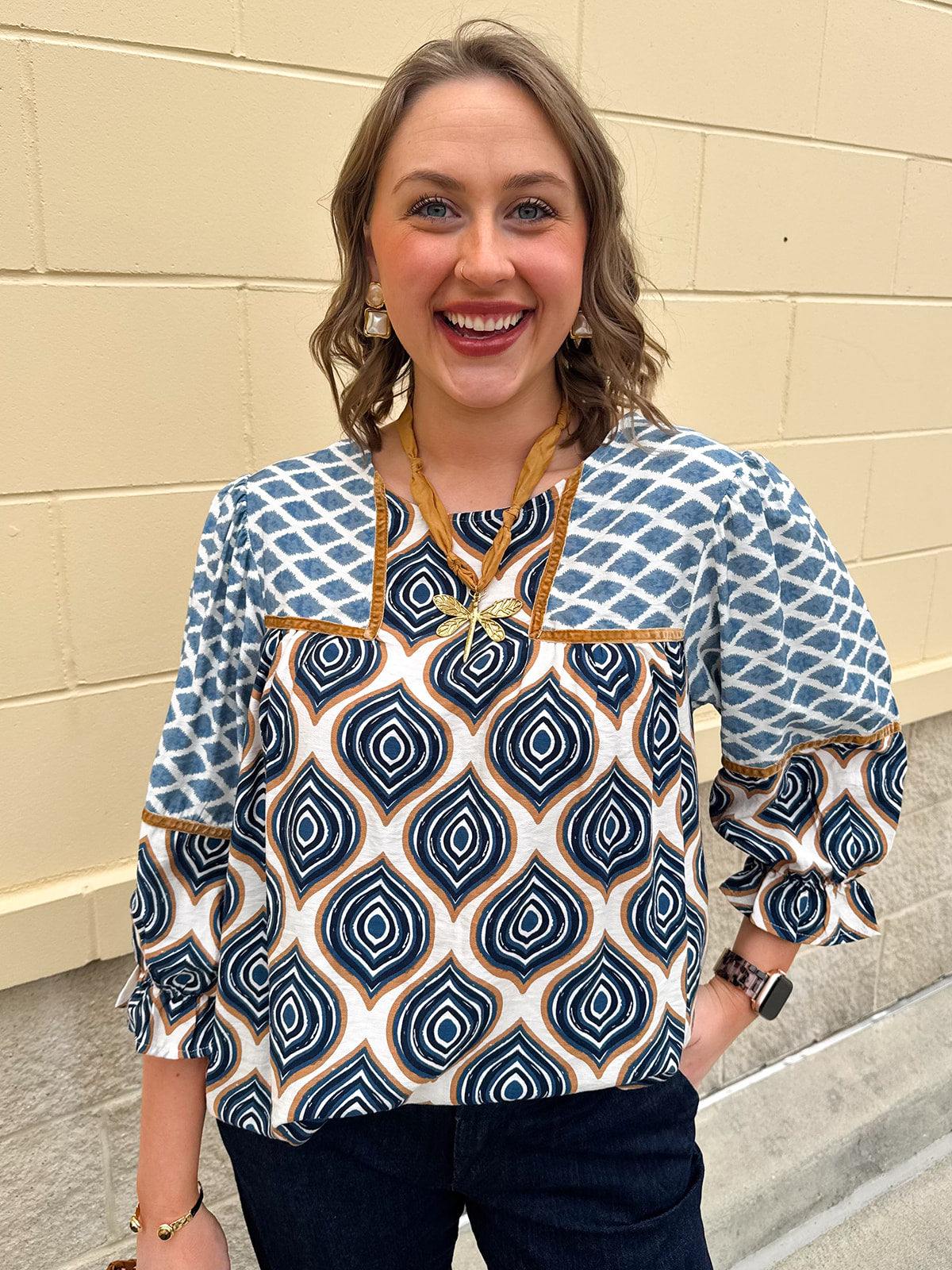 Blue and cream retro geometric print top with velvet trim, ruffle cuffs, and back keyhole.