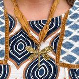 Camel scarf-style necklace with gold metal dragonfly pendant, handmade by Hart Designs.