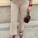 Light brown ash mocha high-waisted bootcut jeans with frayed hem styled for fall.