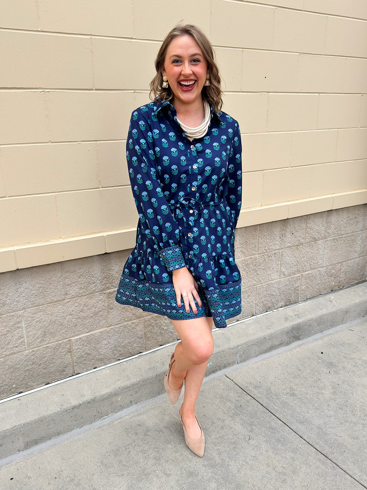 Blue floral print mini shirt dress with long sleeves, button cuffs, and removable belt