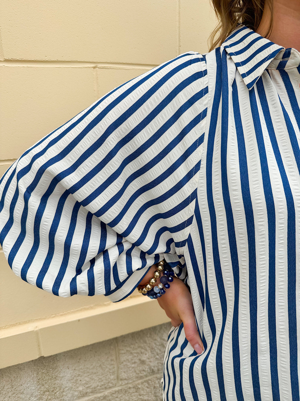 Lightweight striped button-down top in midnight blue and cream with ¾ pirate sleeves, styled for a casual coastal look