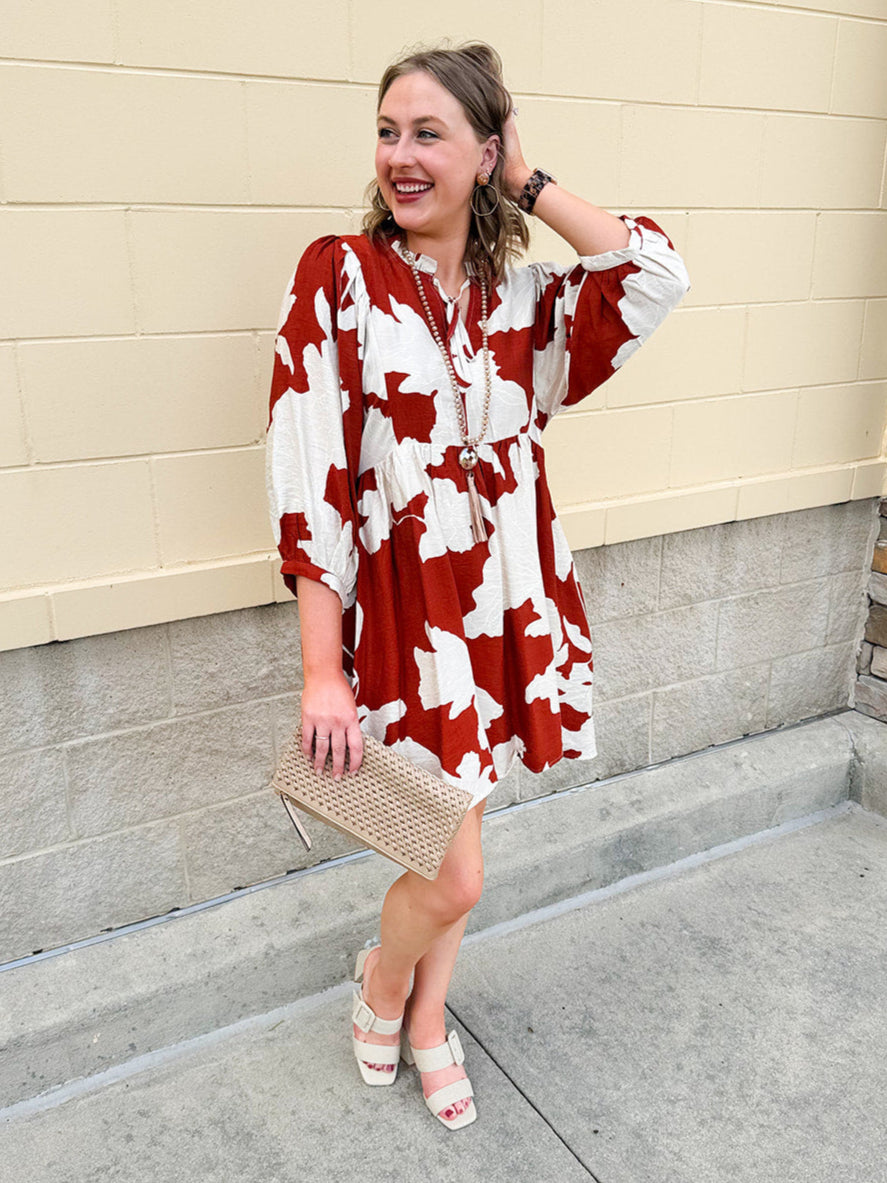 Rust and cream tie-neck mini dress with voluminous sleeves and banded cuffs
