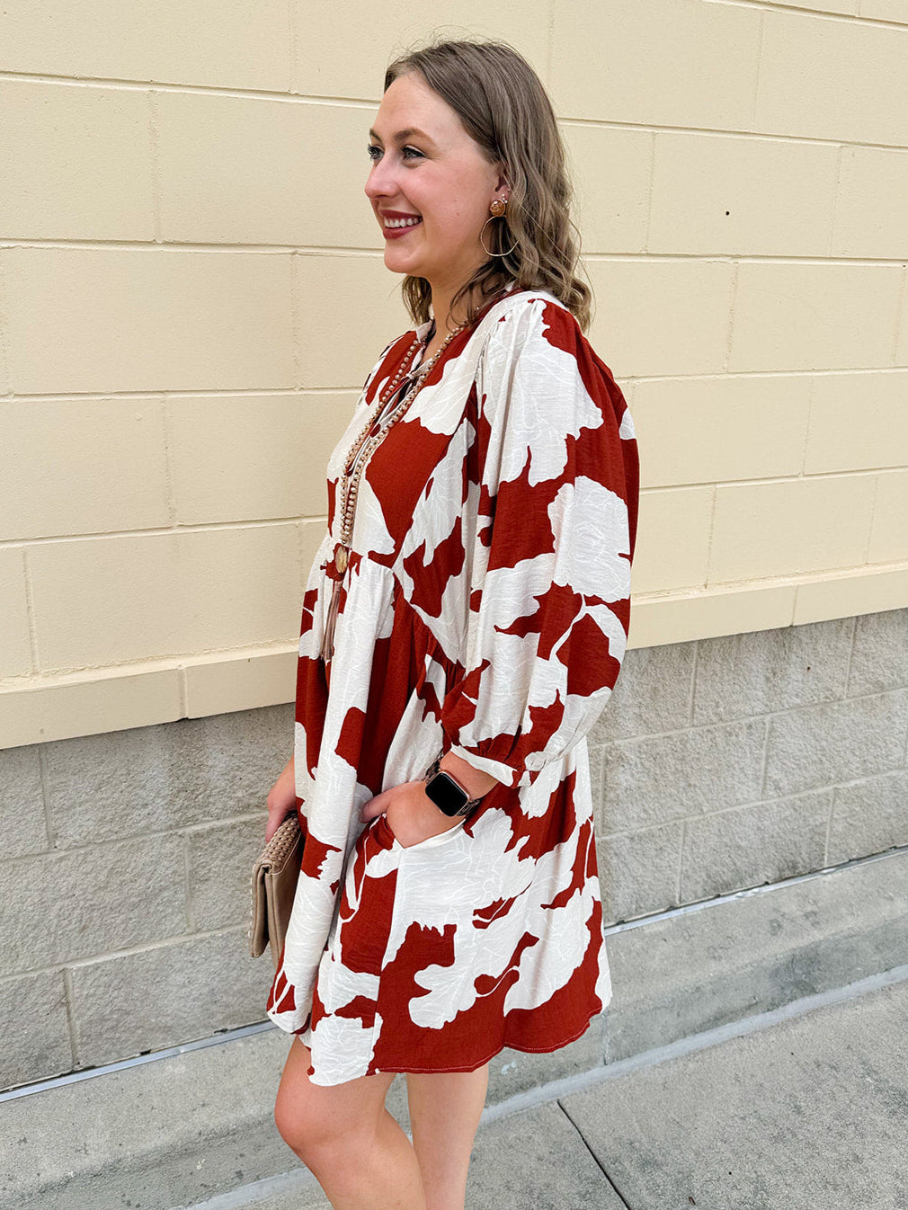 Rust and cream tie-neck mini dress with voluminous sleeves and banded cuffs