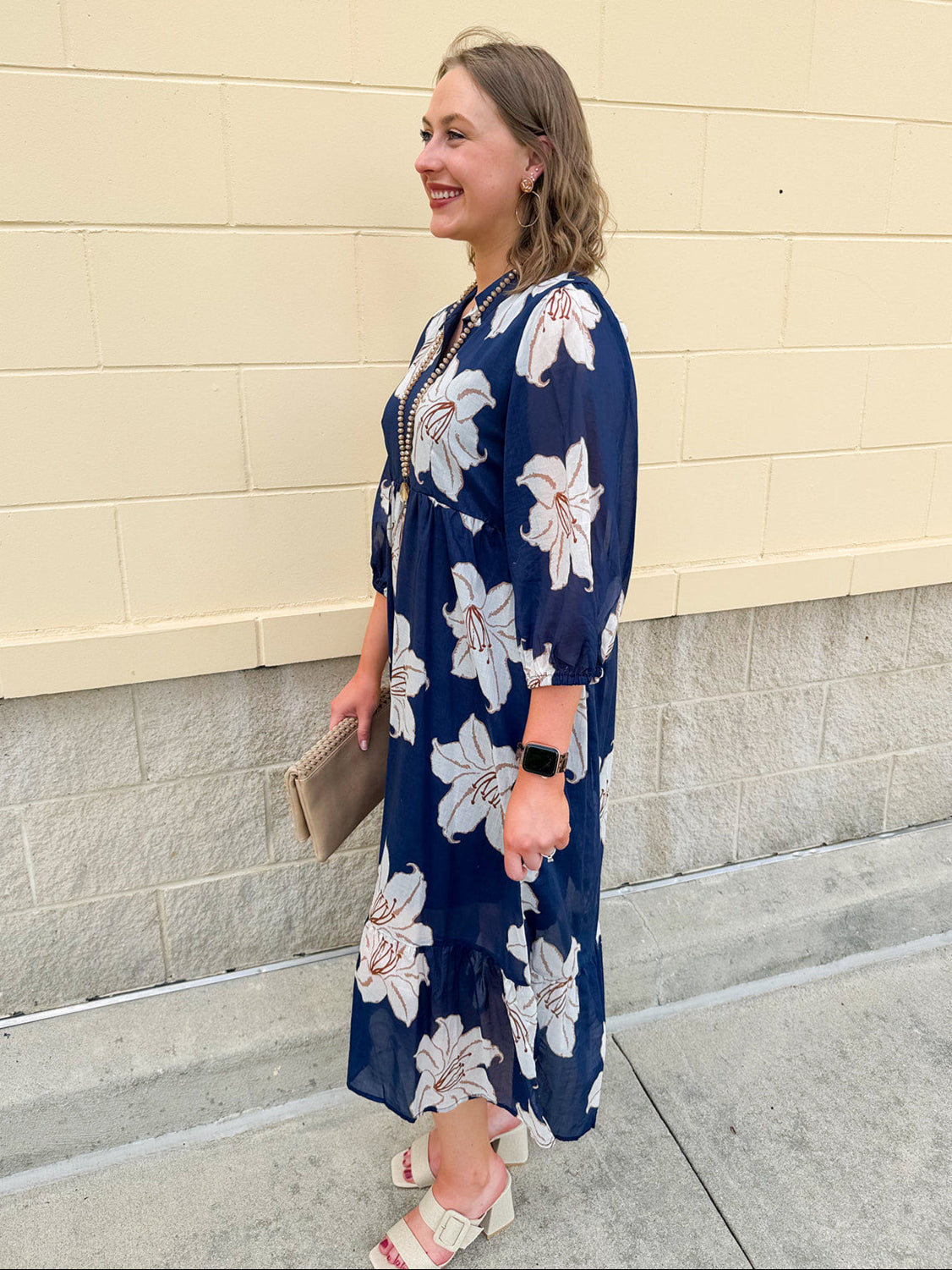 Navy midi dress with white floral details, collar, and 3/4-length sleeves