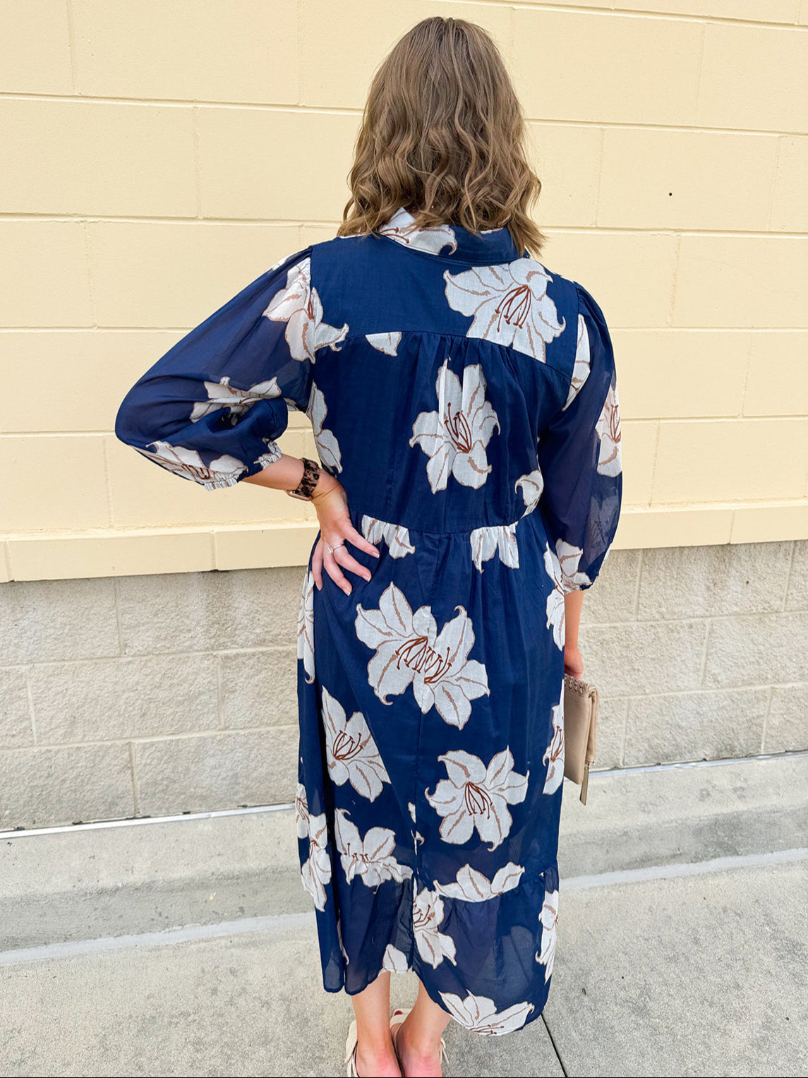 Navy midi dress with white floral details, collar, and 3/4-length sleeves