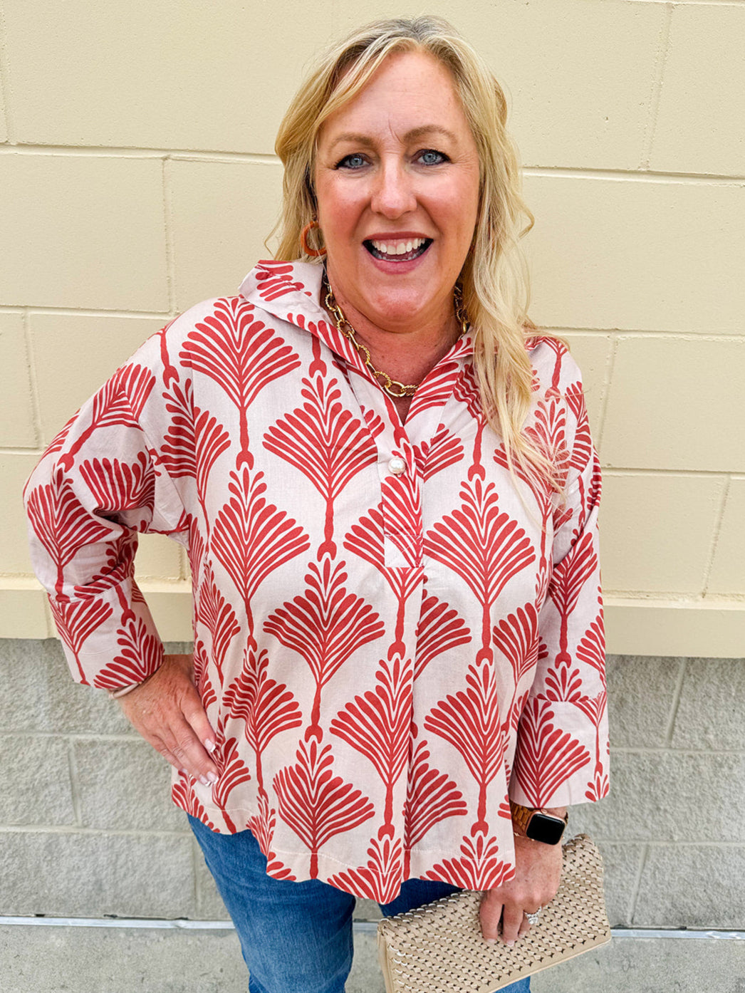 Cream shirt with rust pattern, collar, one button, and ¾-length cuffed sleeves