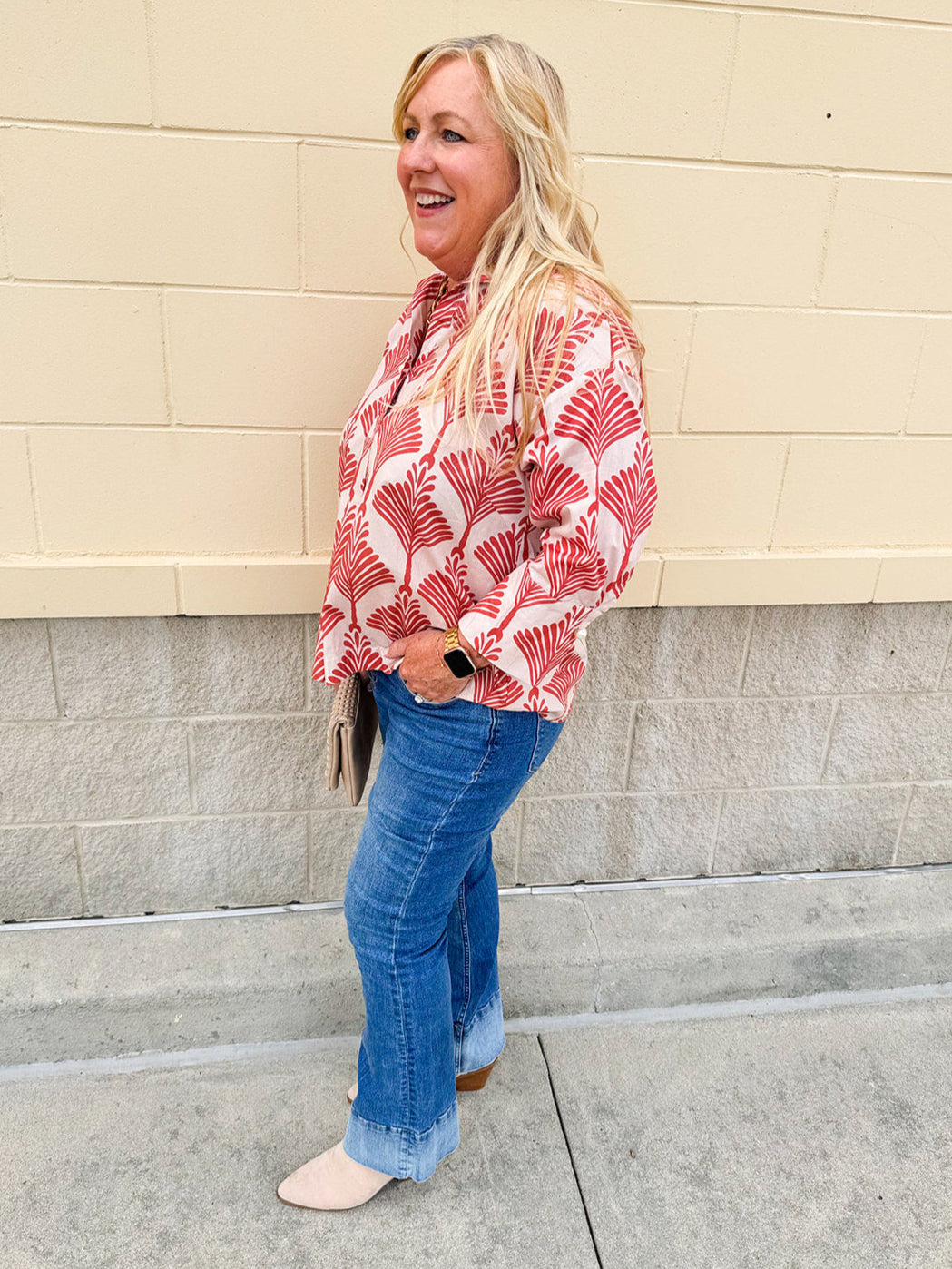 Cream shirt with rust pattern, collar, one button, and ¾-length cuffed sleeves
