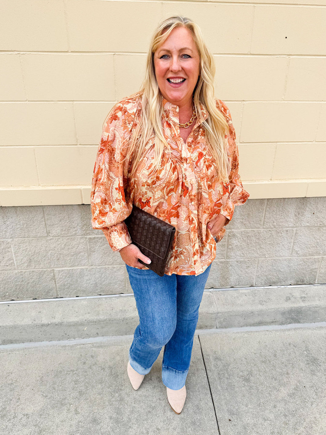 Floral paisley blouse with pleated bib front, balloon sleeves, and a soft standing collar styled for a vintage-inspired look