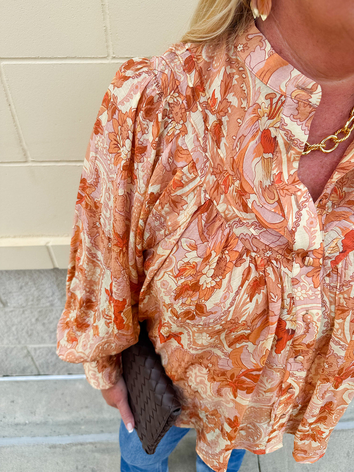 Floral paisley blouse with pleated bib front, balloon sleeves, and a soft standing collar styled for a vintage-inspired look