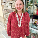 Garnet long sleeve top with v-neck, tie detail, and gold hand-drawn Tallahassee and FSU-inspired illustrations