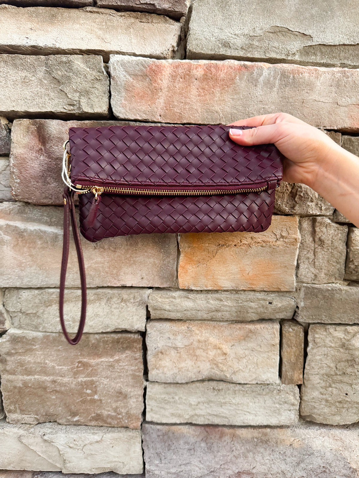 Merlot clutch with gold hardware and wrist strap