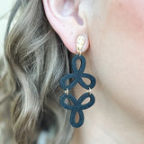 Black and gold drop earrings with two cascading open floral outlines