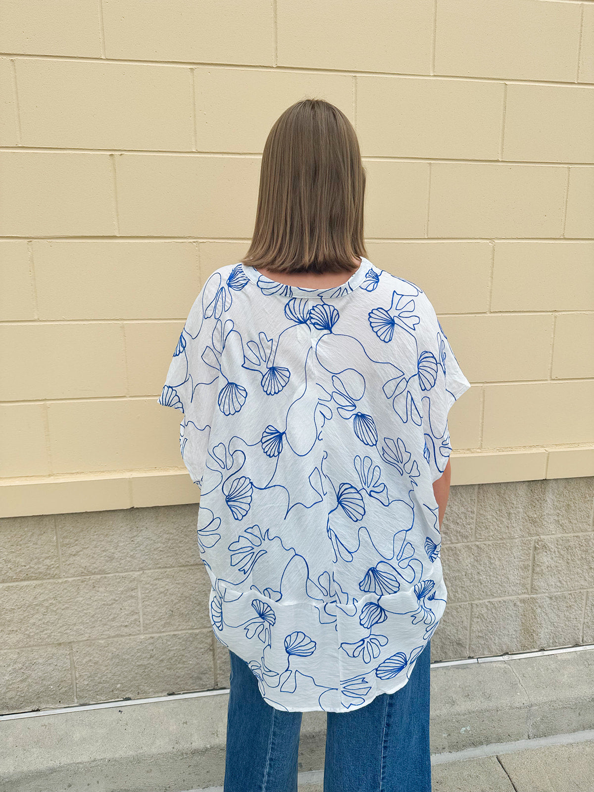 White oversized cotton top with navy seashell embroidery and drop shoulder design