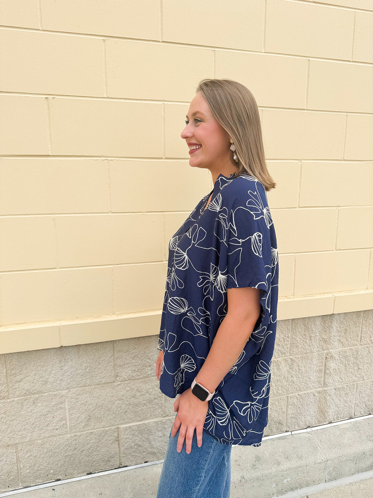 Navy oversized cotton top with cream embroidered seashells and a relaxed silhouette