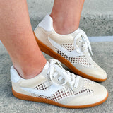 Neutral woven low-top sneakers with muted laces, round toe, and 1-inch heel, styled for casual and fashion-forward everyday looks.